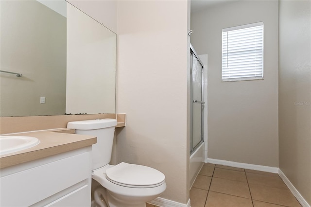 full bathroom featuring enclosed tub / shower combo, tile patterned floors, toilet, and vanity