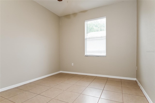 tiled empty room with ceiling fan