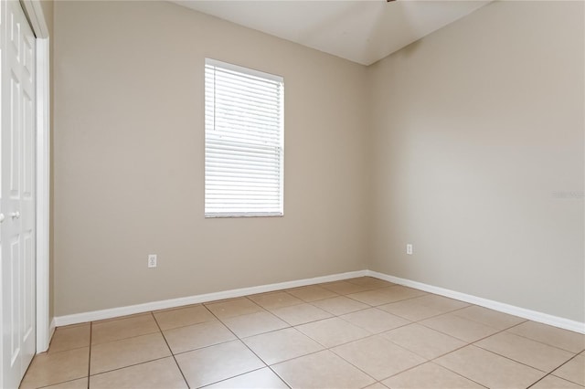 tiled empty room featuring a wealth of natural light