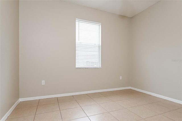 unfurnished room with a healthy amount of sunlight and light tile patterned floors