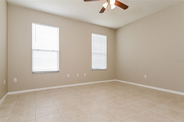 tiled empty room with ceiling fan