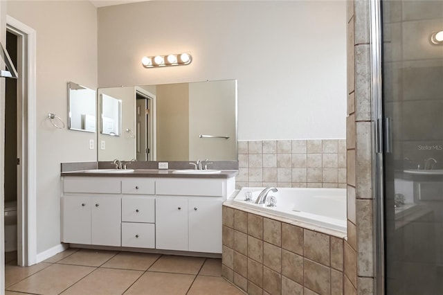 full bathroom with tile patterned flooring, vanity, independent shower and bath, and toilet