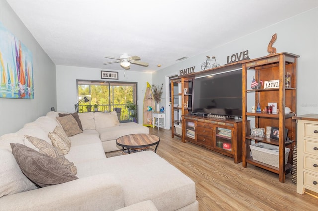 living room with ceiling fan and light hardwood / wood-style floors