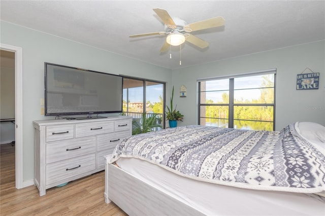 bedroom featuring ceiling fan, access to exterior, and light hardwood / wood-style floors