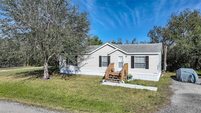 manufactured / mobile home featuring a front lawn