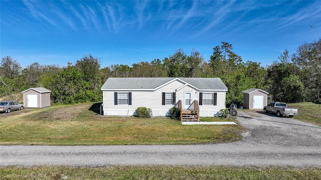 view of front of home with a shed and a front lawn