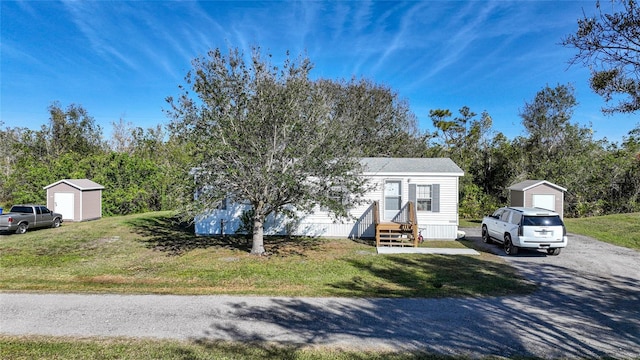 view of front facade featuring a front lawn and a storage unit