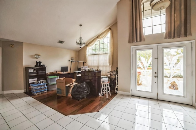 interior space featuring lofted ceiling, a notable chandelier, and french doors