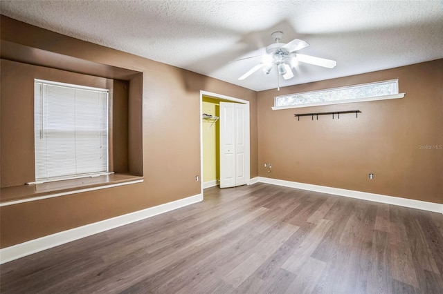 spare room with hardwood / wood-style floors, a textured ceiling, and ceiling fan