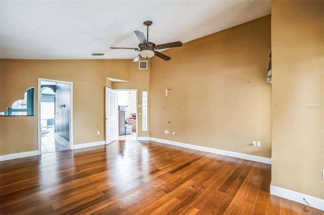 spare room featuring hardwood / wood-style flooring, vaulted ceiling, and ceiling fan