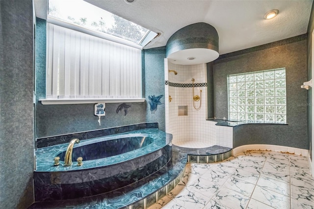 bathroom featuring a textured ceiling, plus walk in shower, and vaulted ceiling with skylight