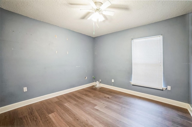 spare room with hardwood / wood-style flooring, a textured ceiling, and ceiling fan