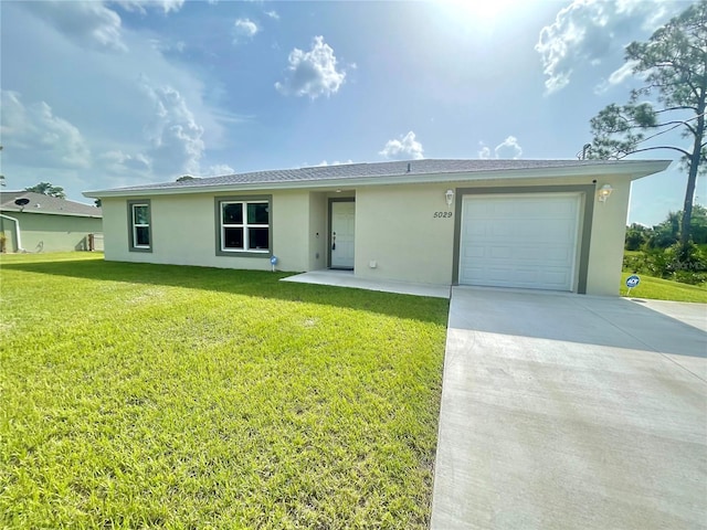 ranch-style house with a garage and a front lawn