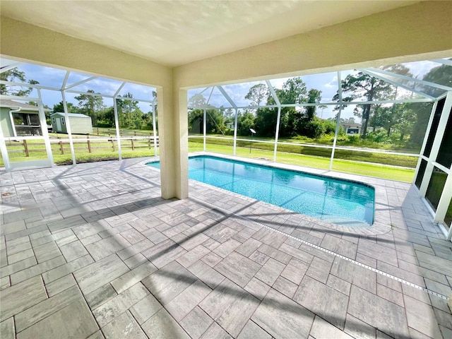 view of pool featuring a yard, a patio, and glass enclosure