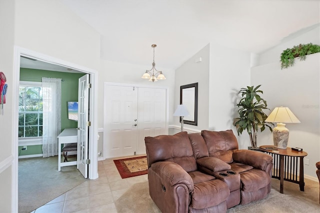 living room featuring vaulted ceiling, light tile patterned floors, and an inviting chandelier