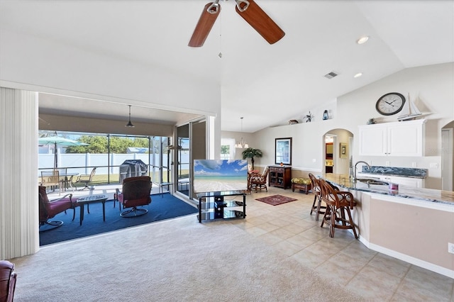 tiled living room with lofted ceiling, sink, and ceiling fan