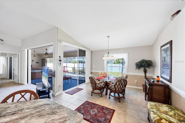 dining room featuring an inviting chandelier, vaulted ceiling, and light tile patterned floors