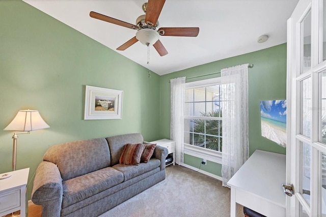 carpeted living room featuring ceiling fan