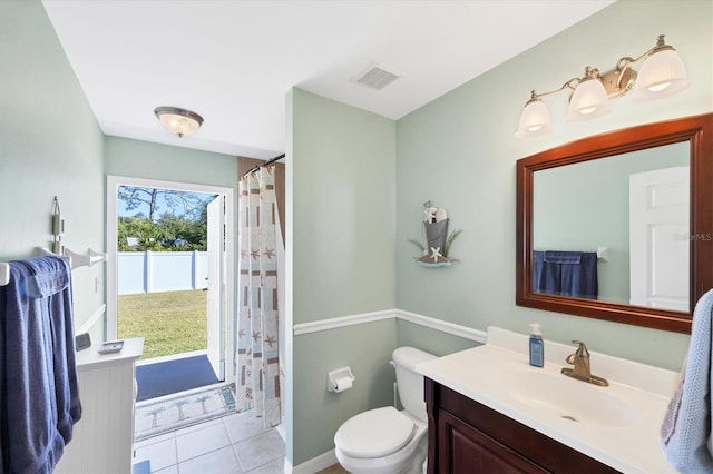 bathroom featuring tile patterned flooring, vanity, and toilet