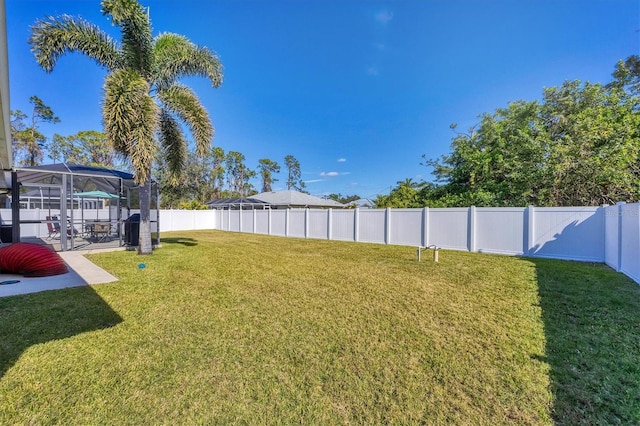 view of yard featuring glass enclosure