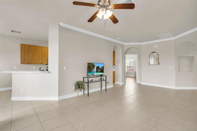 tiled living room featuring ornamental molding and ceiling fan