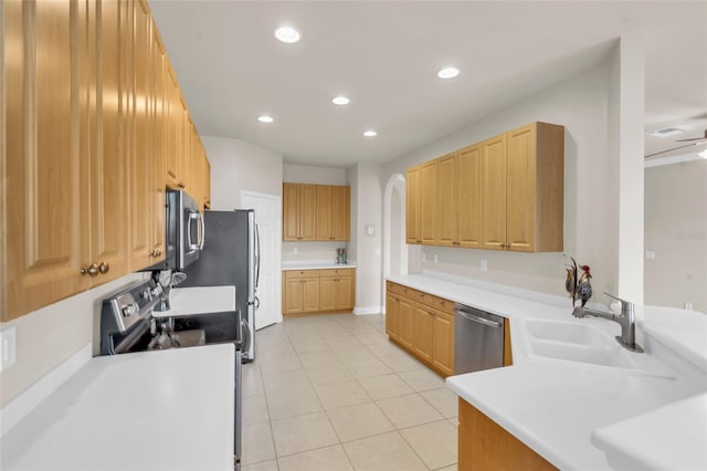 kitchen featuring stainless steel appliances, sink, and light tile patterned floors