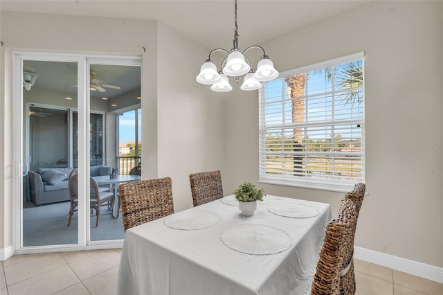 dining room with ceiling fan with notable chandelier and light tile patterned floors