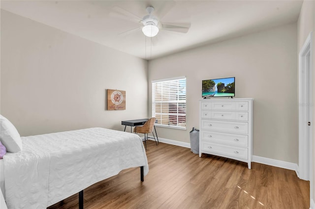 bedroom with hardwood / wood-style floors and ceiling fan