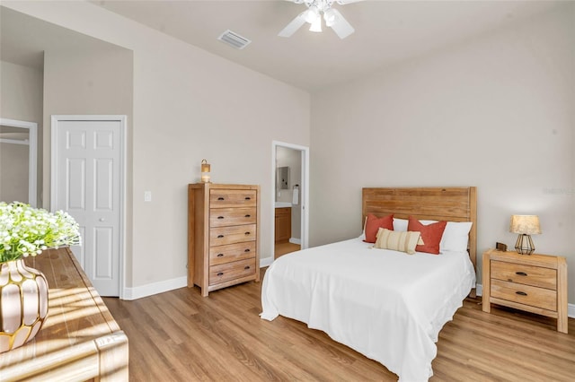 bedroom featuring ceiling fan, wood-type flooring, and ensuite bathroom