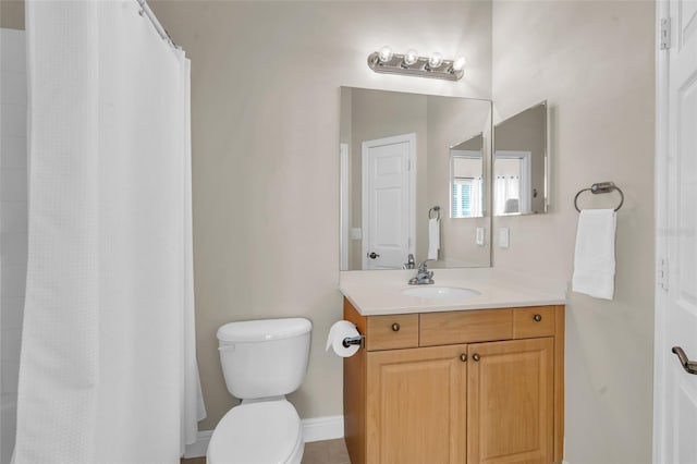 bathroom featuring vanity, a shower with shower curtain, and toilet