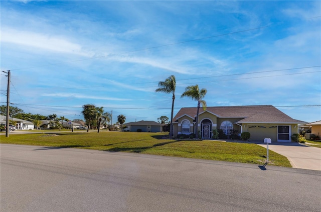 ranch-style house featuring a garage and a front lawn