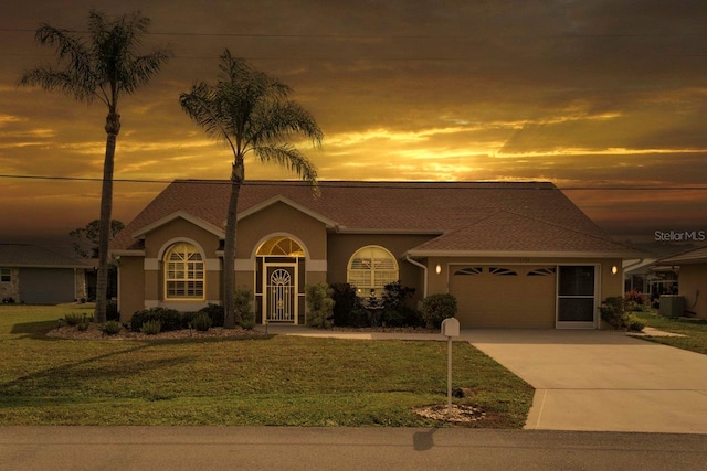 view of front of home featuring a garage, concrete driveway, stucco siding, cooling unit, and a front yard