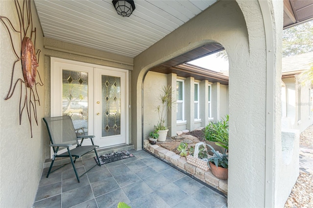 property entrance featuring french doors and a patio area