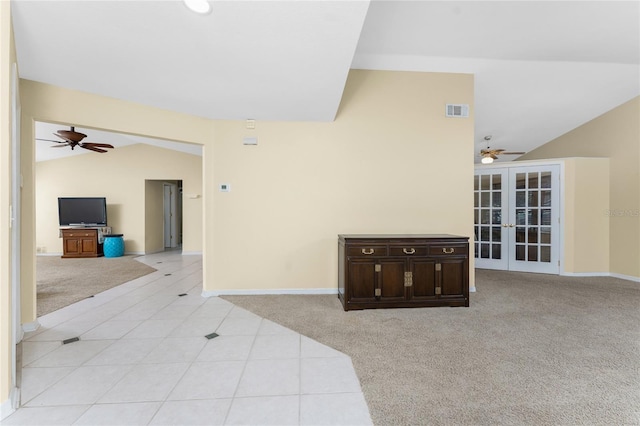 carpeted living room featuring vaulted ceiling, ceiling fan, and french doors