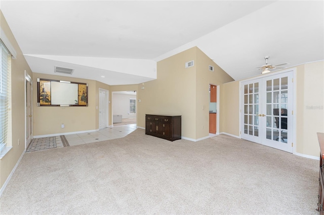 unfurnished living room with french doors, light colored carpet, ceiling fan, and vaulted ceiling