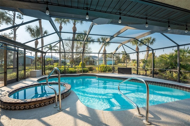 view of swimming pool with an in ground hot tub, glass enclosure, and a patio