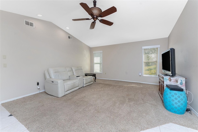 carpeted living room featuring vaulted ceiling, a healthy amount of sunlight, and ceiling fan