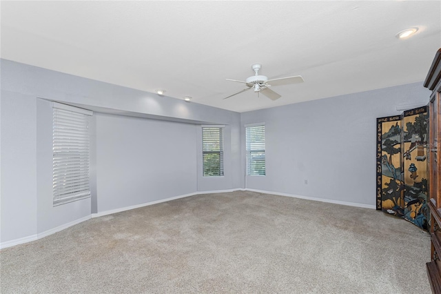 empty room with ceiling fan and carpet