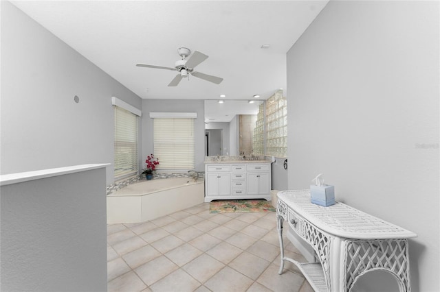 bathroom featuring vanity, tile patterned flooring, a tub, and ceiling fan