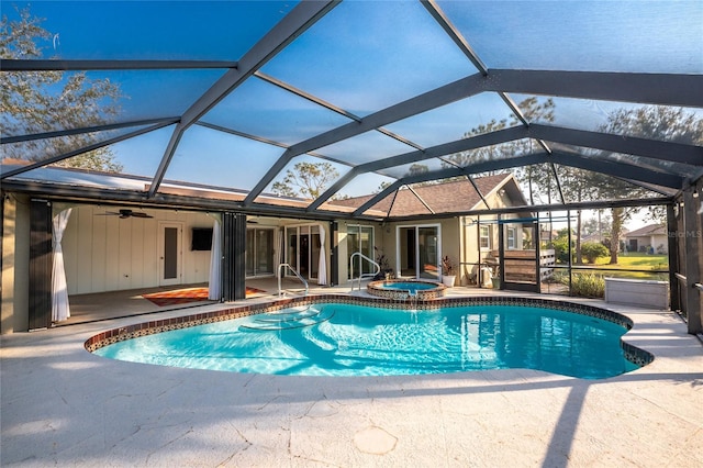 view of swimming pool with an in ground hot tub, ceiling fan, a lanai, and a patio