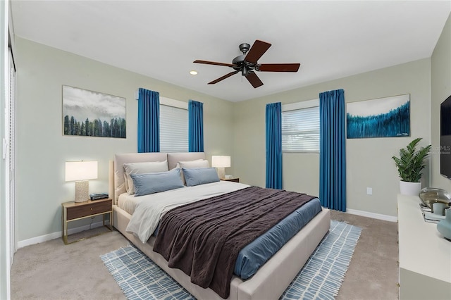 bedroom with light colored carpet and ceiling fan