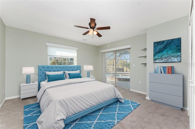 bedroom featuring multiple windows, light carpet, access to exterior, and ceiling fan