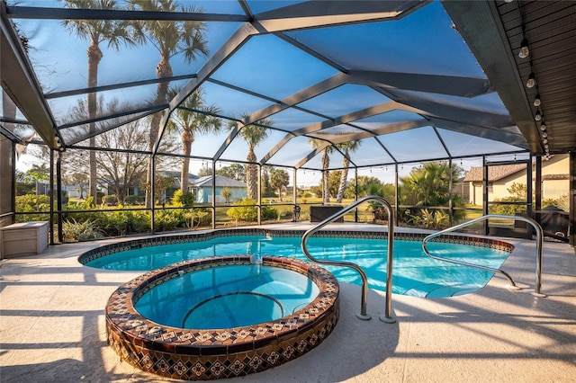 view of pool featuring an in ground hot tub, a lanai, and a patio