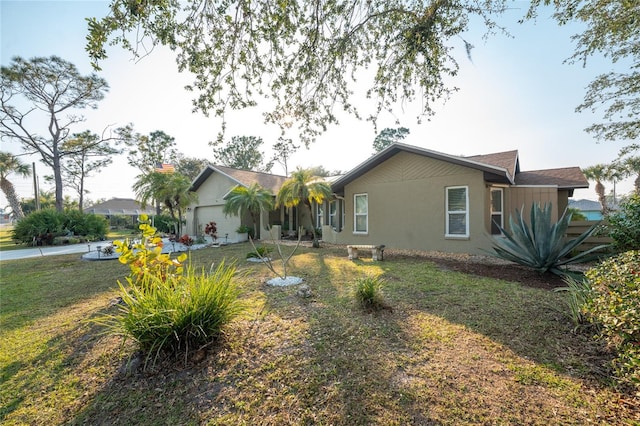 view of front of home with a garage and a front lawn