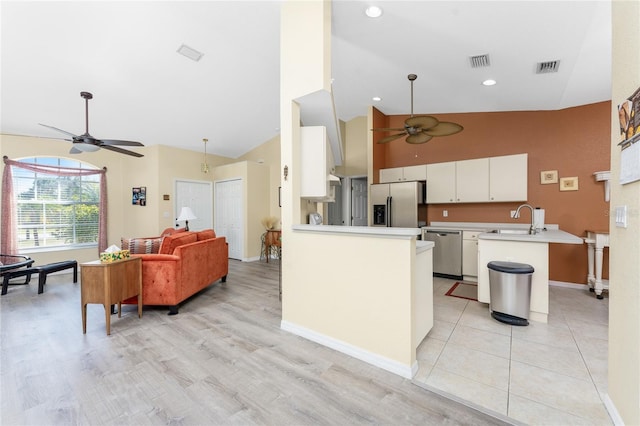 kitchen featuring white cabinetry, ceiling fan, appliances with stainless steel finishes, and kitchen peninsula