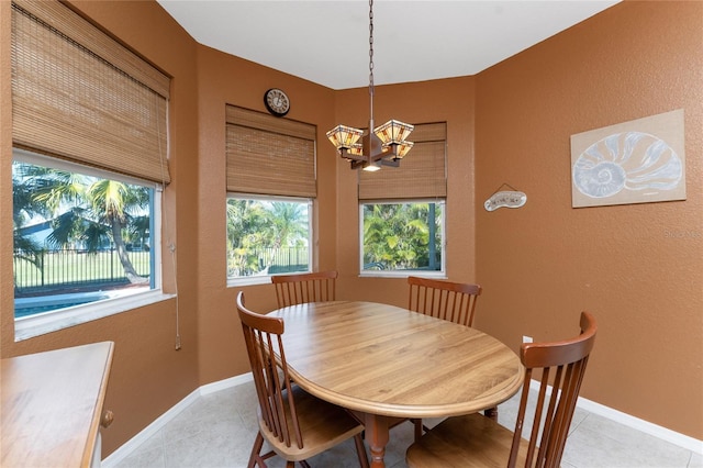 tiled dining area with an inviting chandelier