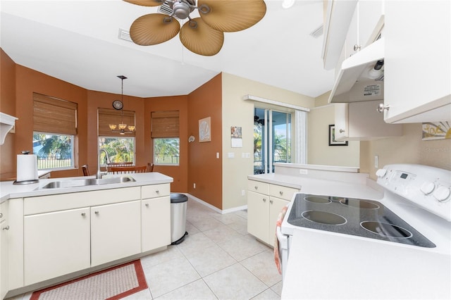 kitchen featuring hanging light fixtures, white cabinetry, sink, and white range with electric stovetop