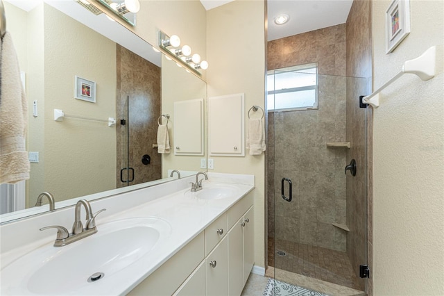 bathroom featuring vanity and an enclosed shower