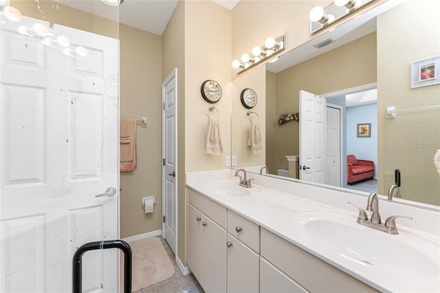 bathroom featuring vanity, toilet, and tile patterned flooring