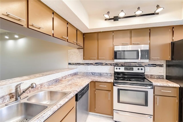 kitchen featuring appliances with stainless steel finishes, sink, and backsplash